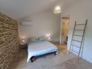 a bedroom with a bed and a ladder in a room at Chez Véro Gîte & Chambres d'hôtes " Le Juvaquatre " in Suze-la-Rousse +82 photos