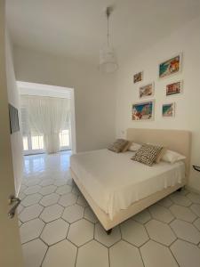 a bedroom with a bed in a white room at Casa Stinga in Capri
