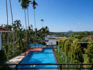 a view of the pool from the balcony of a resort at Karapuzha Water Scapes Wayanad in Wayanad