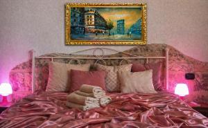 a pink bed with a teddy bear sitting on it at Agriturismo Residence Molle con piscina in Carpignano Salentino