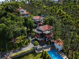 an aerial view of a house with a swimming pool at Karapuzha Water Scapes Wayanad in Wayanad
