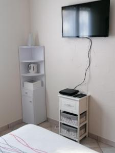 a room with a bed and a lamp on a wall at Les Roches Fleuries in Prunières
