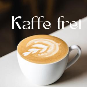 a cup of coffee sitting on a table with the word caffe at Casa Belgeri in Dongio