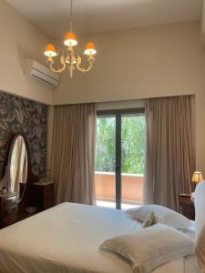 a bedroom with a large bed and a large window at Omma slow living villa in Rafina +112 photos