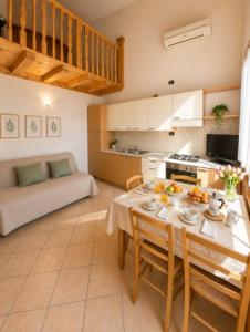 a kitchen and dining room with a table and chairs at Villa Dascia - Agenzia Cocal in Caorle