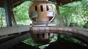 a tree house in the woods with a bridge at Scheunenherberge Schäfchenzählerei in Burg