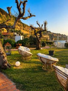 three boats sitting in the grass in a yard at Borgo di Riaci Beach Resort in Santa Domenica