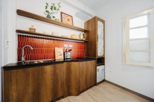 a kitchen with a sink and a counter at Anchie Hanoi House in Hanoi