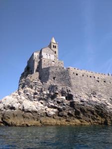 a castle on an island in the water at affittacamere IL GIARDINO la spezia cinque terre in La Spezia