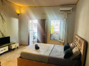 a bedroom with a large bed and a television at Amalis in Moroni