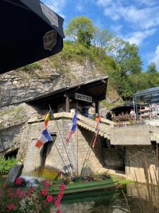 a boat in the water with flags on it at Le P'tit Padré in Jalhay