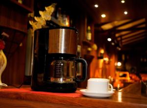 a coffee maker sitting on a counter next to a cup at Diva Villa Airport Transit Hotel in Katunayaka +42 photos