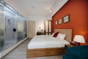 a bedroom with a large bed and a shower at Anchie Hanoi House in Hanoi