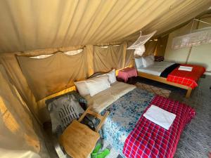 an overhead view of a tent with a bed and a bed at Treasure camp in Maasai Mara National Reserve