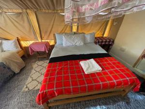 a bedroom with a bed in a tent at Treasure camp in Maasai Mara National Reserve