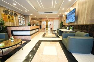 a lobby of a hotel with blue chairs and tables at فندق النخبة الماسي - Diamond Elite Hotel in Medina