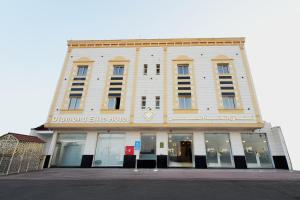 a large white building with a sign on it at فندق النخبة الماسي - Diamond Elite Hotel in Medina