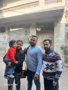 a group of three people standing in front of a building at Agam Homestay-Two Minutes Walk From Golden Temple in Amritsar