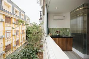 an internal courtyard of a building with a garden at Anchie Hanoi House in Hanoi