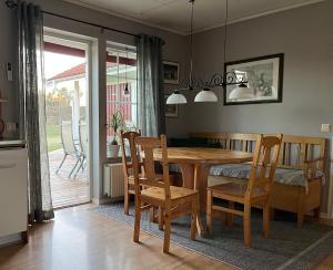 a dining room with a wooden table and chairs at Aspudden en pärla i Sörmland in Vingåker