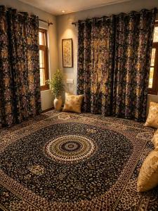 a room with a large rug on the floor at SH Valley Homestay in Srinagar