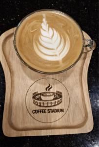 a cup of coffee on a wooden tray at Destination Boutique Hotel in Pattaya