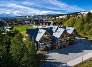 an aerial view of a house with solar panels on it at BANIA BLACK MOUNTAIN I basen & spa in Białka Tatrzańska