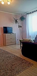 a living room with a couch and a dresser at Liudmila in Liepāja