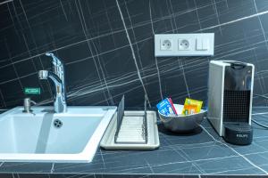 a sink with a faucet and a counter top at Corner-Set Cholet Centre in Cholet +27 photos