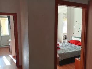 a room with a bedroom with a bed and a mirror at Абай2 169 in Astana