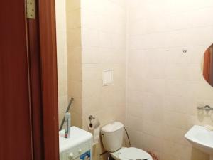 a small bathroom with a toilet and a sink at Абай2 169 in Astana