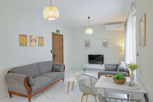 a living room with a couch and a table at Aphrodite Old Town Suite Xanthi in Xanthi
