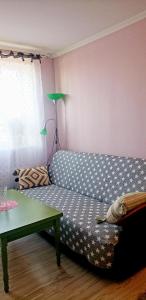 a living room with a couch and a table at Liudmila in Liepāja