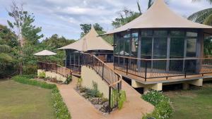 a large building with a tent on top of it at The Halfway Cafe-Dauin, Glamp1 - Cricket in Dauin