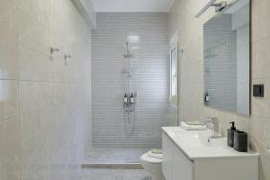 a bathroom with a shower and a toilet and a sink at Aphrodite Old Town Suite Xanthi in Xanthi +17 photos