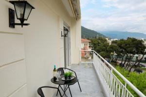 a patio with a table and chairs on a balcony at Aphrodite Old Town Suite Xanthi in Xanthi