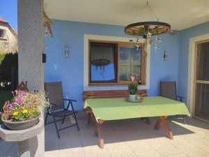 a patio with a green table and a couch at Fewo Puxberg in Niederwölz
