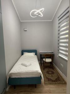 a bedroom with a bed and a ceiling fan at Ala-Archa Mountain House in Vorontsovskoye