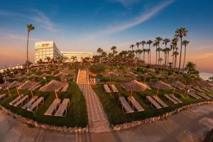 arial view of a resort with lounge chairs and palm trees at Cavo Maris Beach Hotel & Suites in Protaras +56 photos