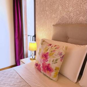 a pillow sitting on a bed next to a lamp at Teresa Caeiro in Oia