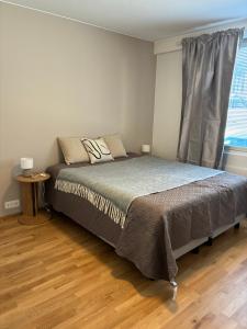 a bedroom with a large bed with a window at Huoneisto Vipunen in Savonlinna