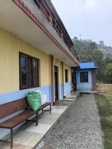 a bench outside of a house with a building at Saura place Homestay in Nagarkot