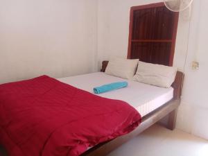 a bed in a room with a red blanket on it at Anna Koh Rong in Kaôh Rŭng (3) +7 photos