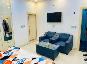 a living room with a couch and a tv at Hotel Grand Radhe Krishna inn in Vrindāvan
