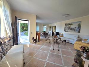 a living room with a couch and a table at Queen Apartment - Stunning Panoramic Island View in Baveno