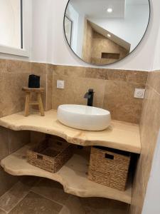 a bathroom with a sink and a mirror at Les remparts de Sasha in Lapalme +17 photos