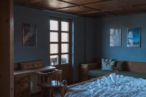 a bedroom with a bed and a chair and a window at Superseegarten in Bad Wiessee