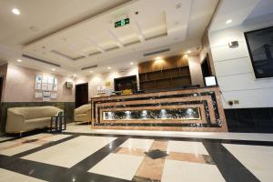a lobby with a fireplace in a building at شقق اللؤلؤة الذهبي - Golden Pearl Apartments in Sīdī Ḩamzah +15 photos