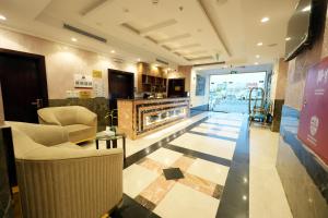 a lobby with chairs and a fireplace in a building at شقق اللؤلؤة الذهبي - Golden Pearl Apartments in Sīdī Ḩamzah