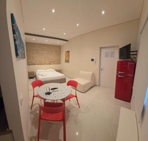 a living room with a table and chairs and a couch at Althea B&B in Schiavonea